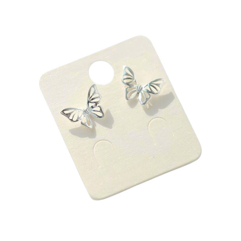 A pair of silver earrings on a white background