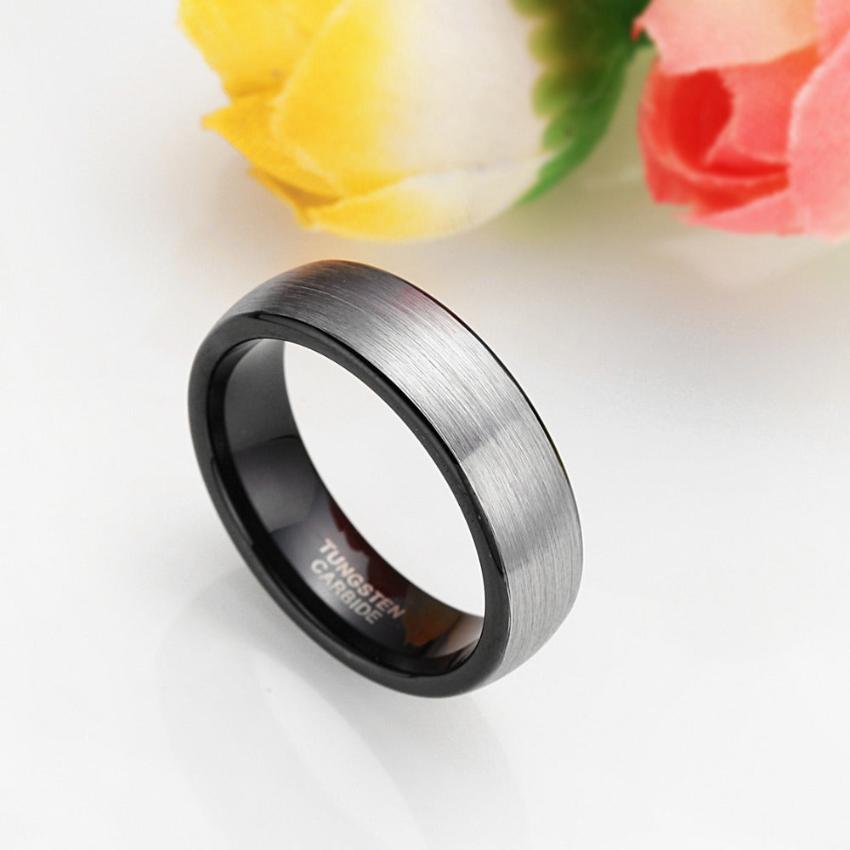 A tungsten carbide silver ring over a white surface