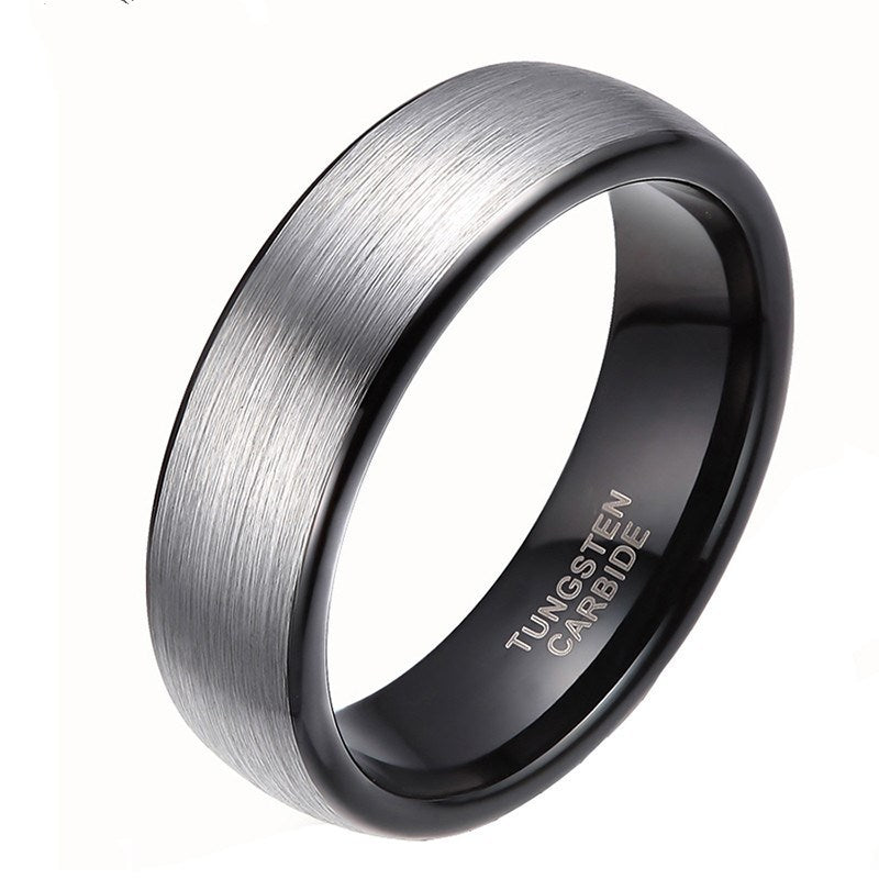 A close view of a tungsten carbide ring with a silver finish on a white canvas