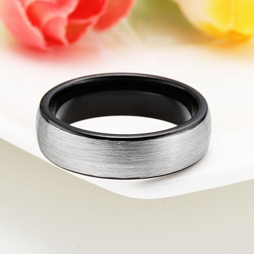 A ring made of tungsten and silver finish lying on a white table