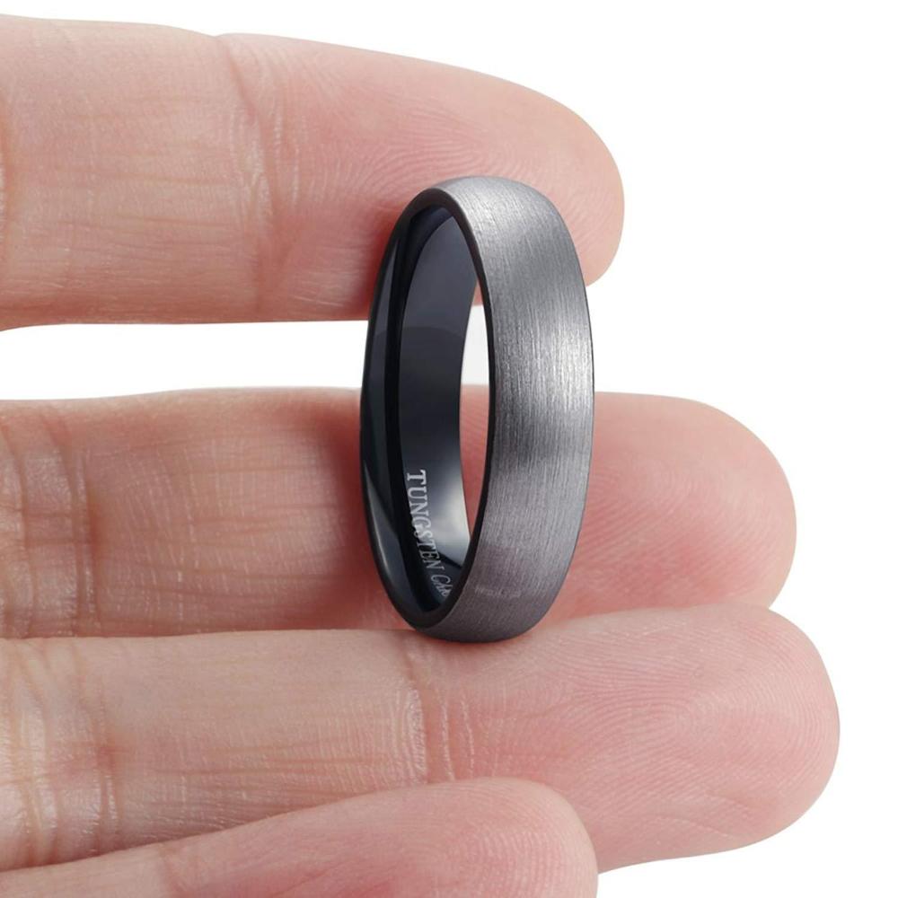 an elegant tungsten black ring on a human hand