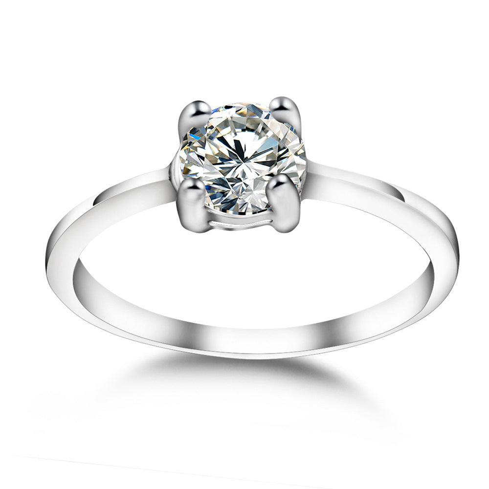 Elegant wedding ring with a zircon on a white canvas