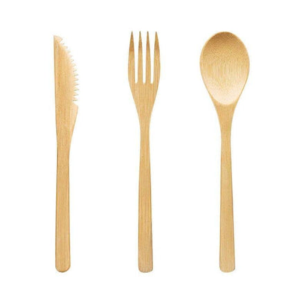 Bamboo knife, fork, and spoon on a white canvas