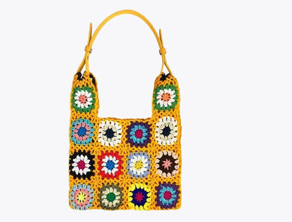 Women's handcrafted braided bag adorned with a multicolored floral pattern