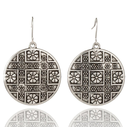 Antique-style silver earrings with detailed ornamental patterns