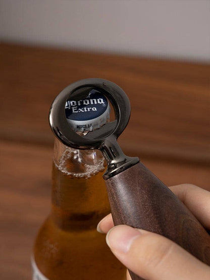 Hand holding a creative vintage stainless steel bottle opener