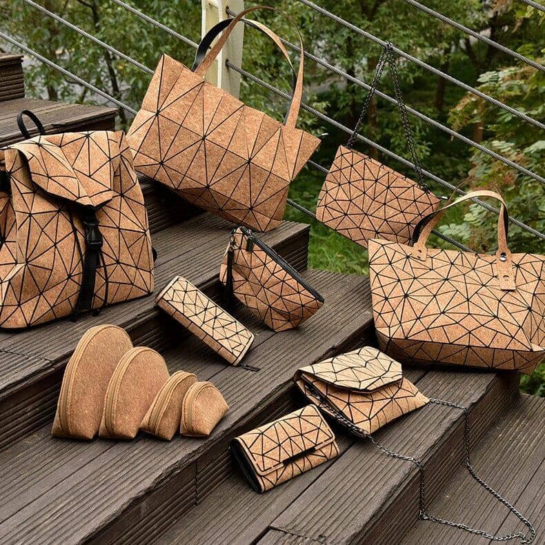 Assortment of eco-friendly cork wallets and accessories arranged on outdoor steps