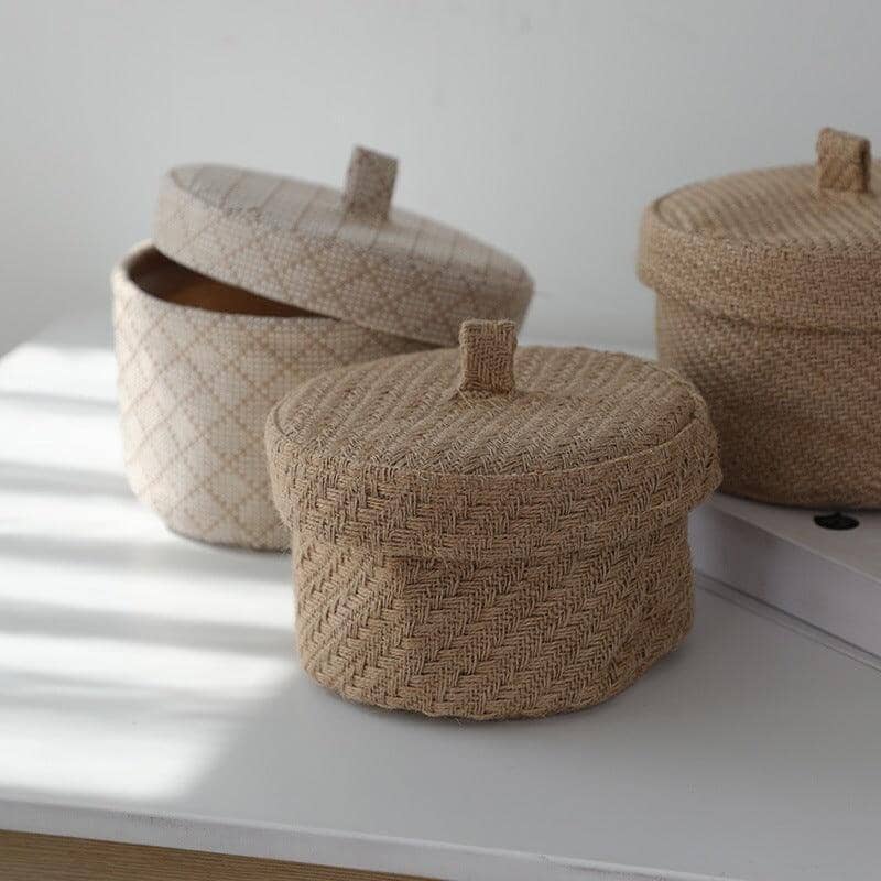 three different storage basket made of eco-friendly jute and linen on a white table