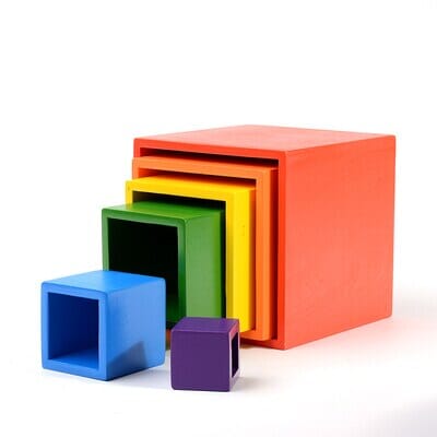 6 pieces of colored pine wood cube blocks on a white canvas