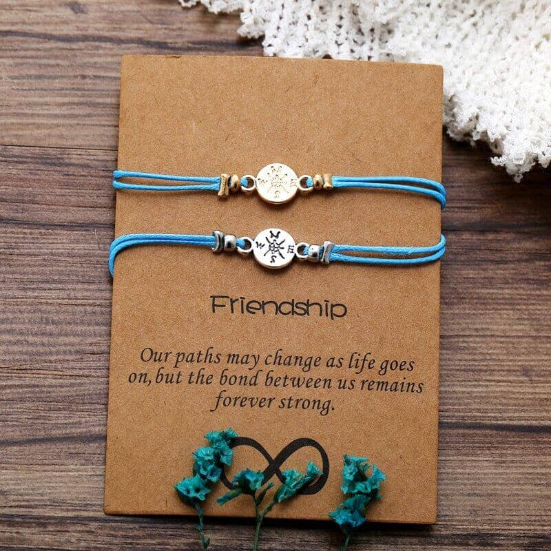  2 friendship bond bracelets with a message over a wooden surface