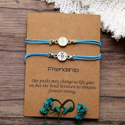  2 friendship bond bracelets with a message over a wooden surface