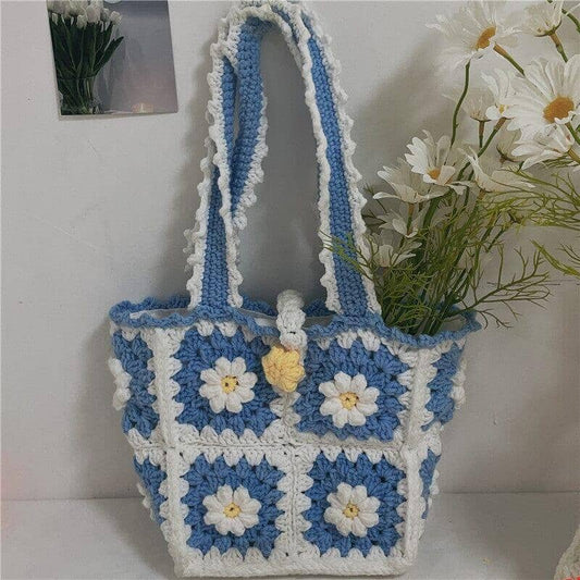 hand knitted bag crochet in white and blue with a flower pattern