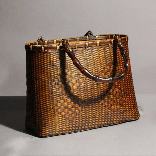 Handcrafted brown bamboo bag with a traditional design and carrying handle