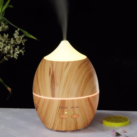 A sustainable natural wood aroma diffuser on a table with a white cover