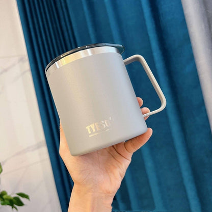 Someone holding an eco-friendly grey stainless steel mug