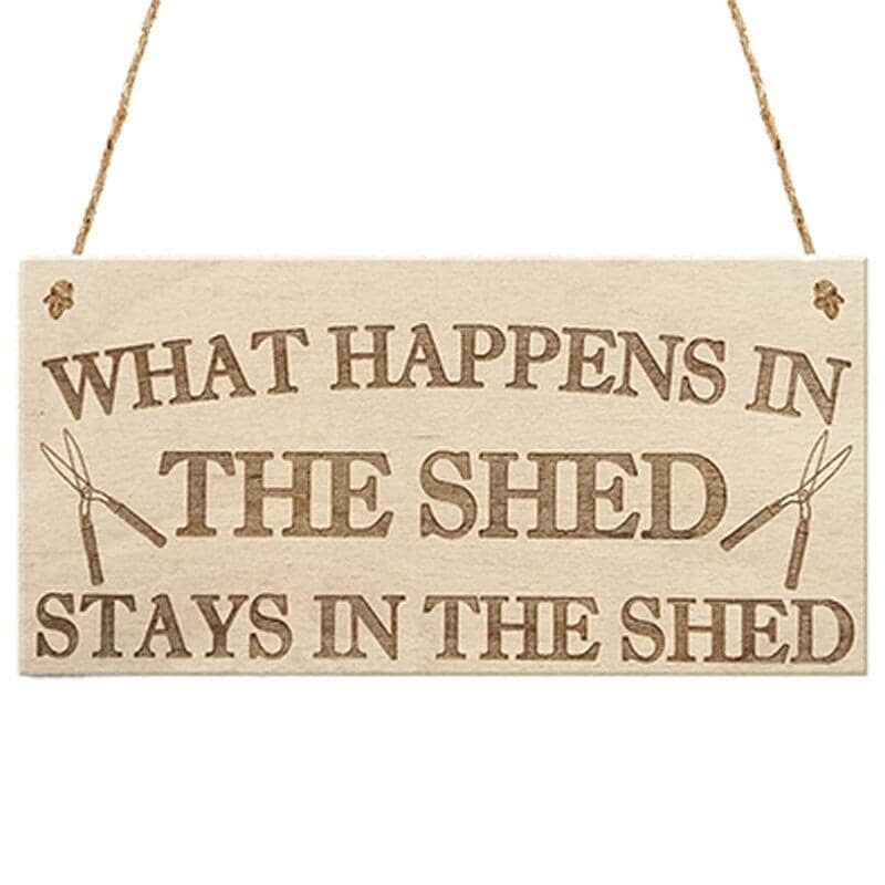 A wooden pendant plaque for home entrance decoration with message the shed stays in the shed