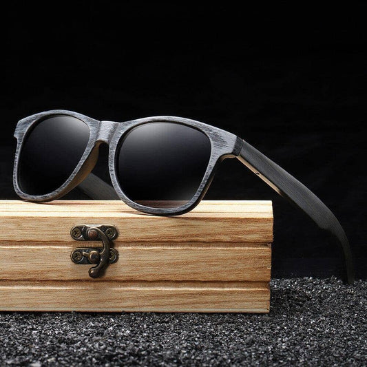 Black sunglasses solid wood on top of a wooden box