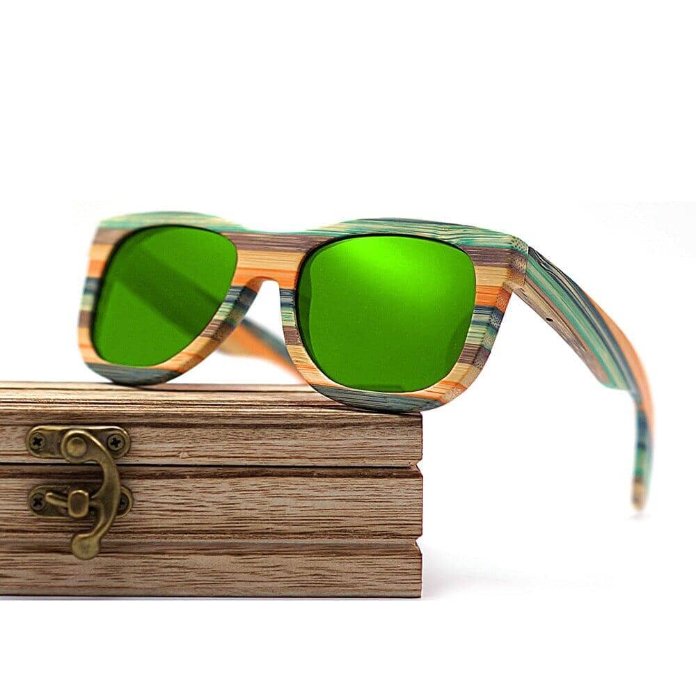 wooden box and wood glasses with bright green glass glasses on a white background