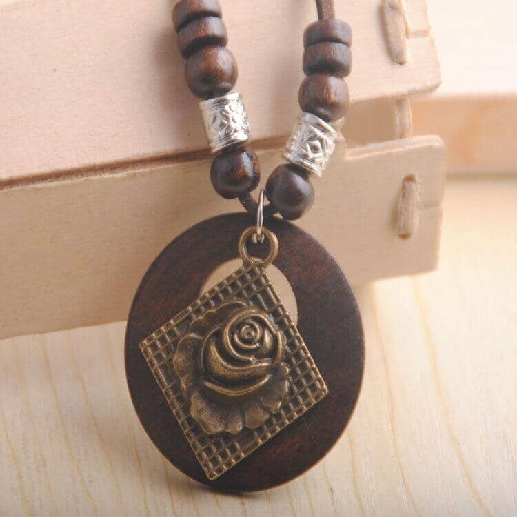 a retro wooden necklace with a rose and a diamond in the middle