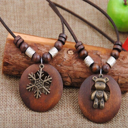 2 different wooden necklaces exposed over a piece of wood