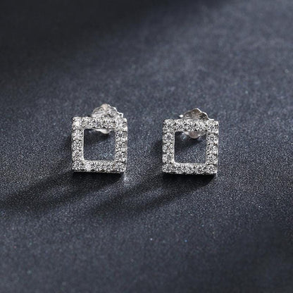 A pair of silver earring with micro-inlay brighten gemstones 