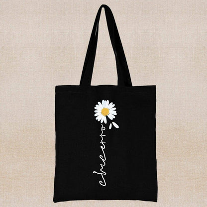 An eco-friendly and sustainable black tote bag with a margarita flower 