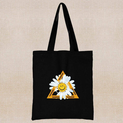 An eco-friendly and sustainable black tote bag with a smile margarita flower in a triangle 