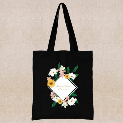 An eco-friendly and sustainable black tote bag with a message card and flowers