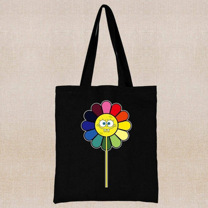 An eco-friendly and sustainable black tote bag with a smile face in a rainbow color flower