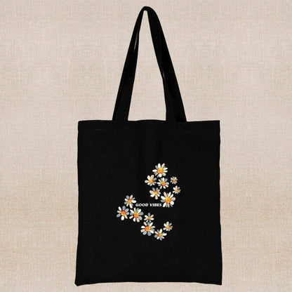 An eco-friendly and sustainable black tote bag with message of good vibes