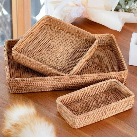 storage basket made of rattan of different dimensions on a wood surface close to a window