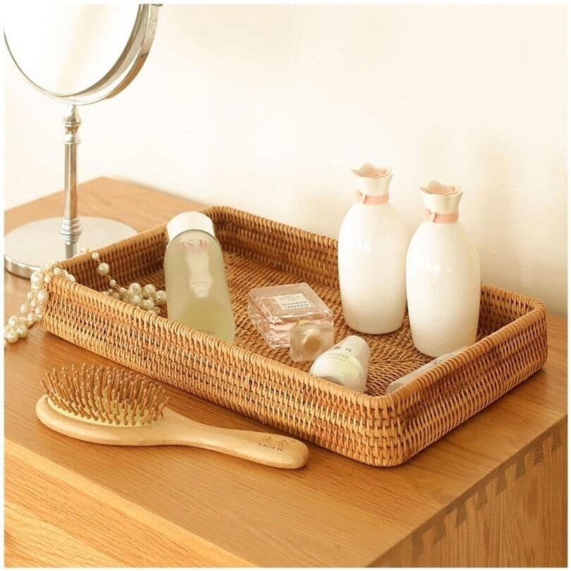 a elegant storage basket made of rattan with different products and a hair brush besides