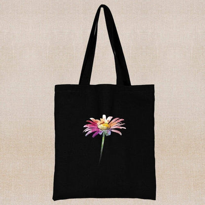 An eco-friendly and sustainable black tote bag with a multicolored flower in the center