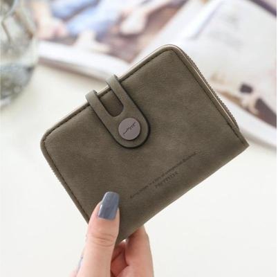 Woman's fingers showing a vegan faux leather purse for women green color