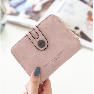 woman's hand showing a vegan faux leather purse for women PINK
