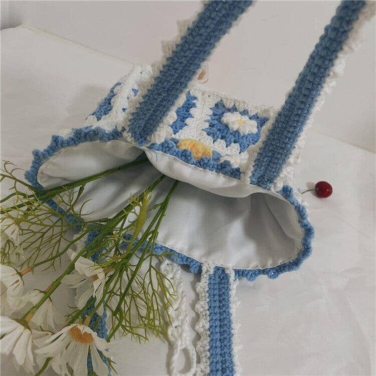 a opened hand knitted shoulder bag crochet with a white floral pattern